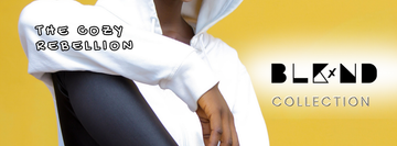 gold background with BLKxND (Black and Neurodivergent) logo. the words "The Cozy Rebellion" are on the arm sleeve of a woman wearing a White hoodie. the  BLKxND logo is black with collection underneath it.
