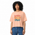 Woman with curly hair wearing a peach cropped t-shirt with 'Summer Recovery Mode' text and retro graphics on a white background